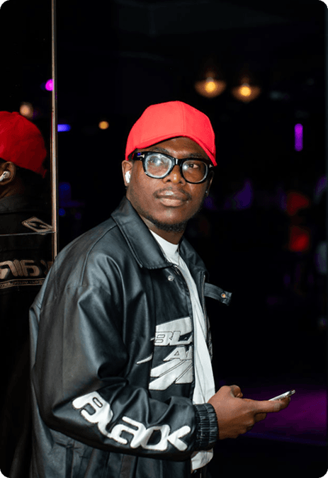 Young man in red cap and black leather jacket